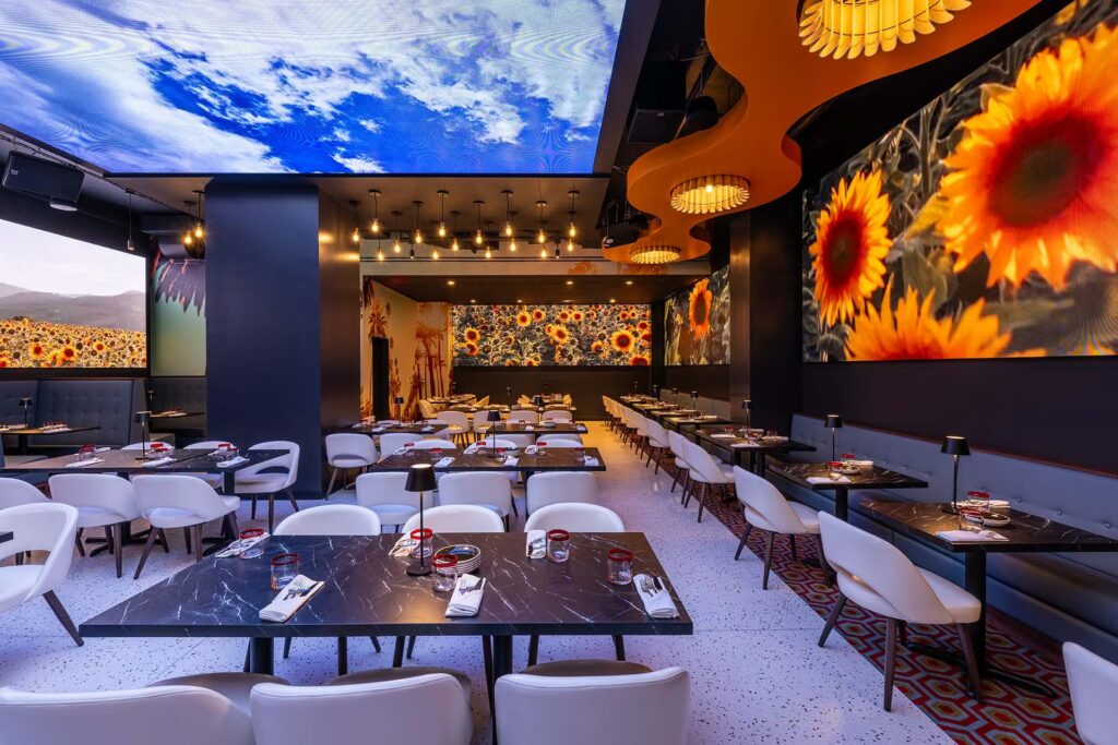 The dining room inide Planet Hollywood, showing projections of flowers and the sky