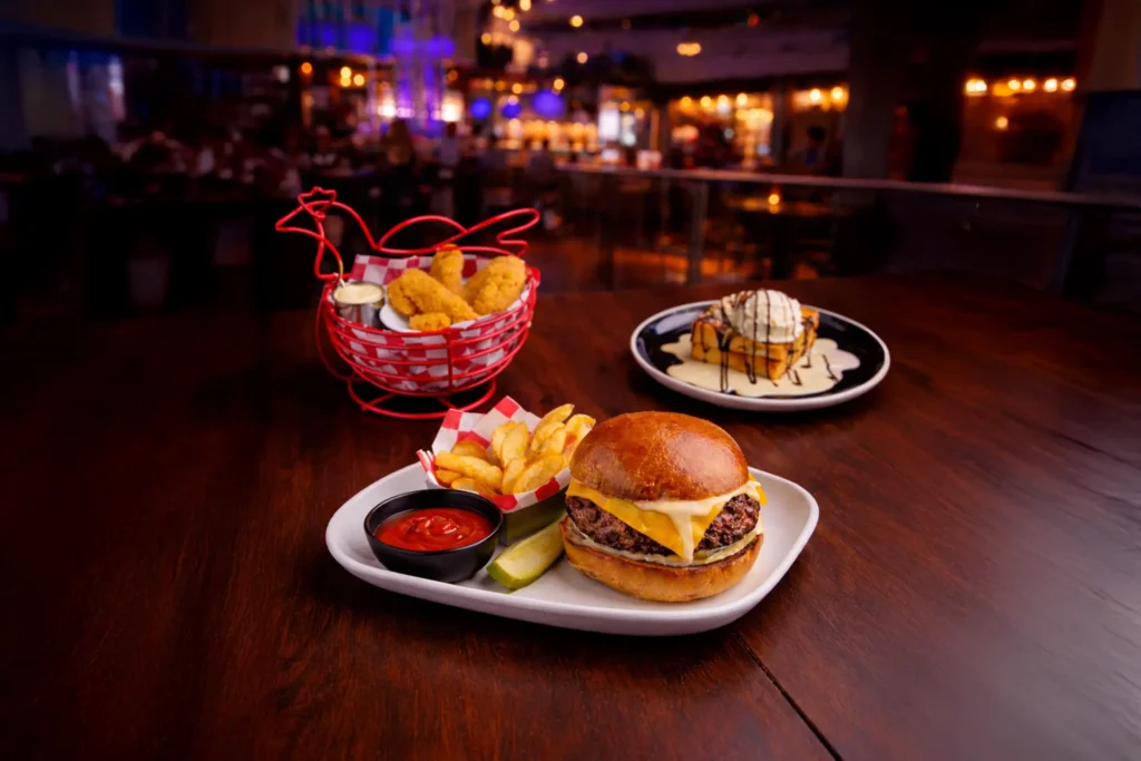A three-course NYC Restaurant Week meal at Planet Hollywood Times Square featuring World Famous Chicken Crunch, a Cheeseburger Cheeseburger with fries, and Chocolate Chip Bread Pudding.