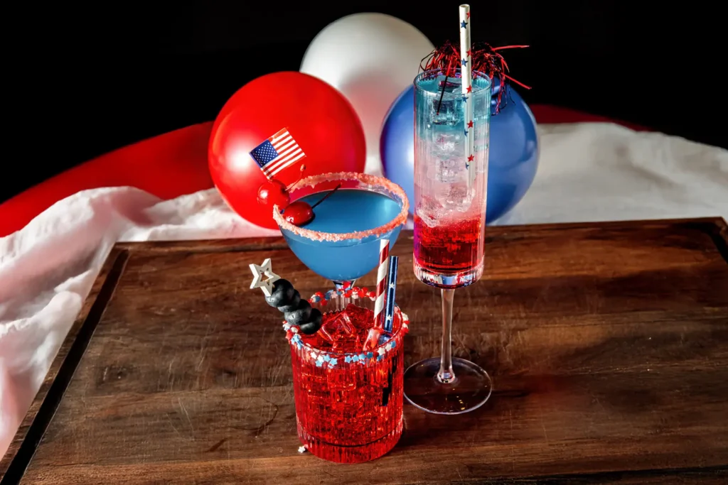 Patriotic America 250 cocktails served with red, white, and blue balloons.