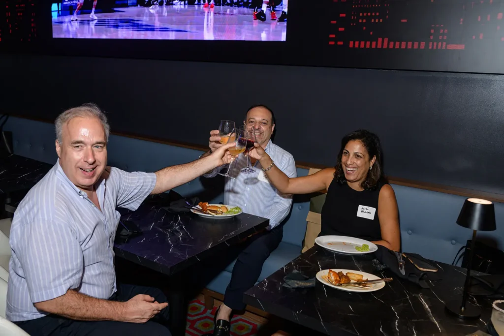 Three guests raising glasses during a private event at Planet Hollywood NYC