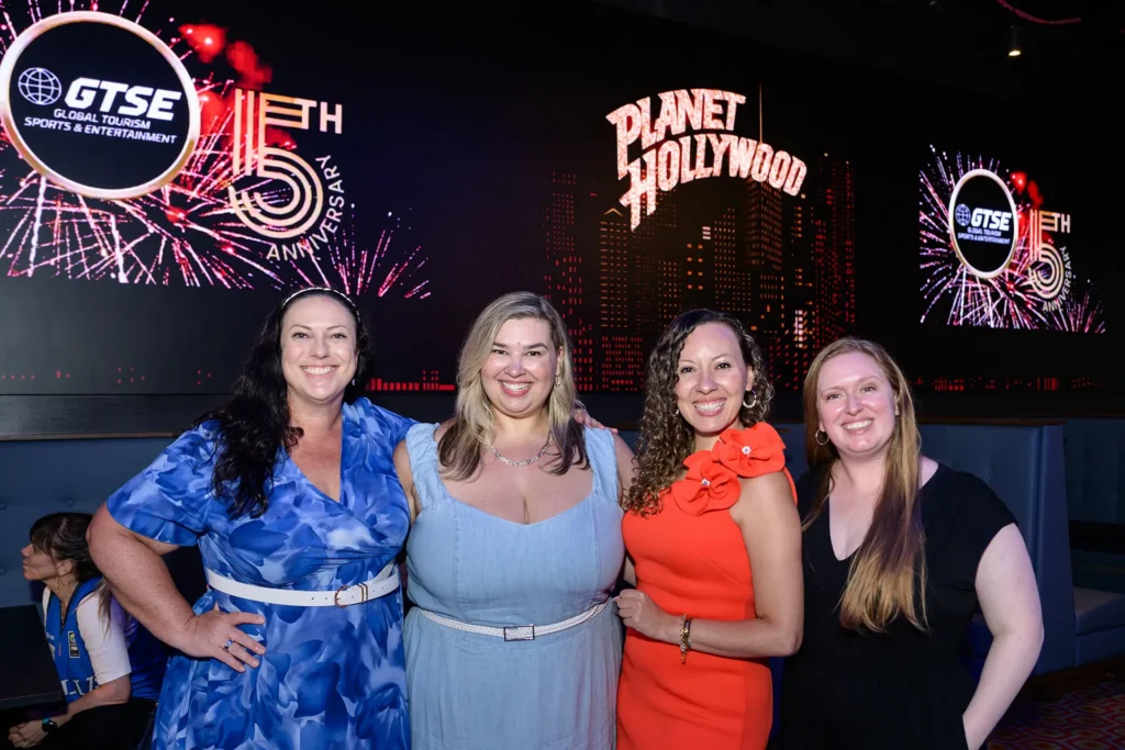 Four guests posing together at a GTSE anniversary event at Planet Hollywood NYC